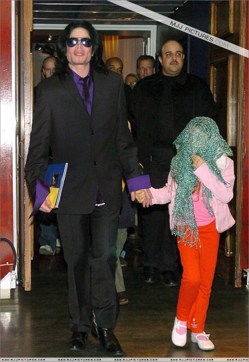 Singer Michael Jackson with one of his children as he arrives for a private visit to Madame Tussauds