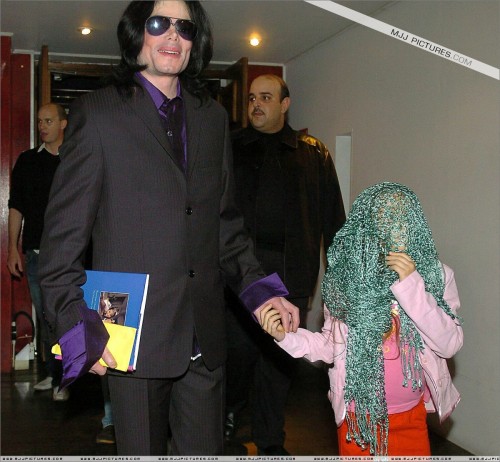 Singer Michael Jackson with one of his children as he arrives for a private visit to Madame Tussauds